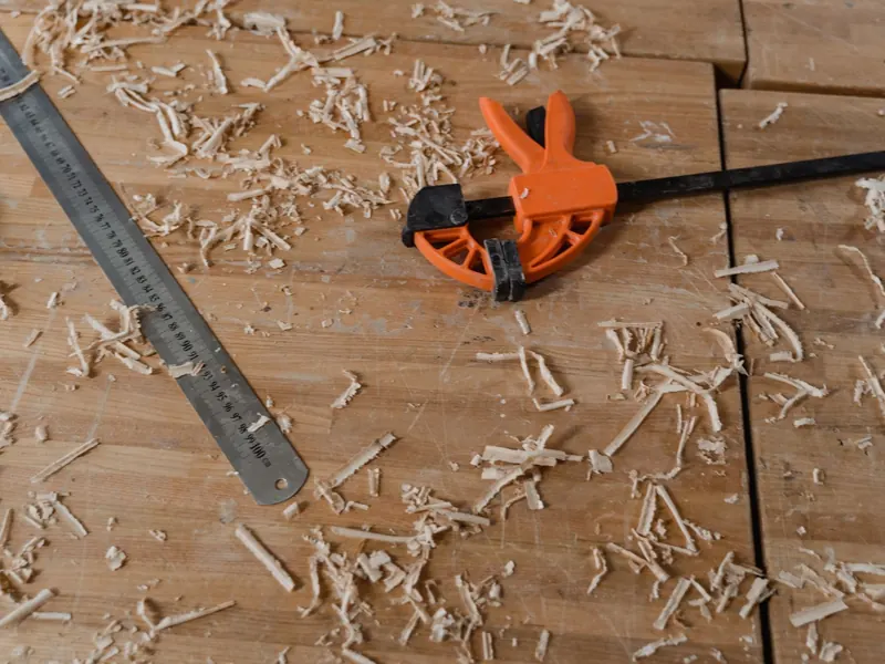 Woodworking tools and fresh wood shavings on a workshop bench