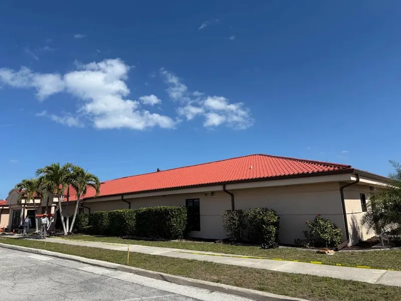 Single-storey commercial building with a bright red metal roof