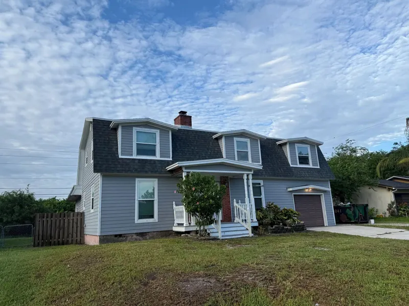 Two-storey blue home with a new charcoal architectural shingle roof